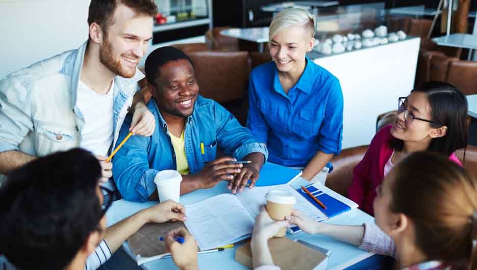 Group of students spending break in cafe
